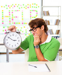 Student struggling at the exam in classroom