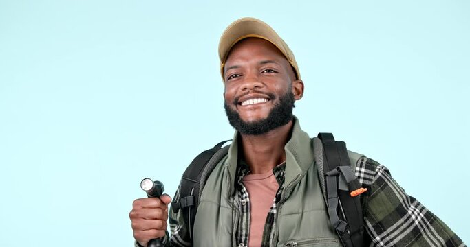 Backpack, freedom and black man trekking in studio happy, adventure and fitness journey on blue background. Hiking, smile and African guy backpacker smile, explore and excited for travel or discover