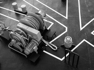 Deck markings with electric winch and mooring line on the foredeck of a cruise ship - obrazy, fototapety, plakaty