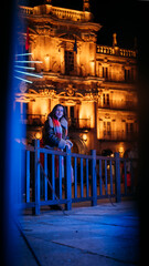 Pretty young girl with scarf admiring the Christmas lights. 