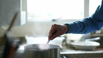 Senior person Close-up hand cooking food by kitchen sink, food preparation