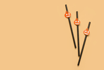 Drinking straws for Halloween celebration on color background