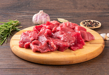 Goulash - pieces of beef or lamb meat on a cutting board.