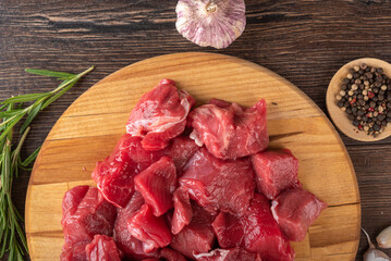 Close-up of goulash - pieces of beef or lamb meat on a cutting board.