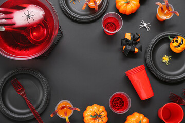 Halloween party table setting with punch and decor on black background