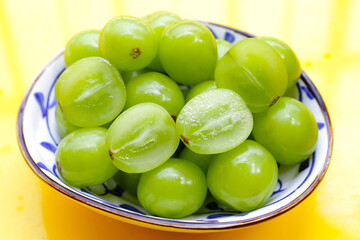 Shine muscat grape on yellow background.