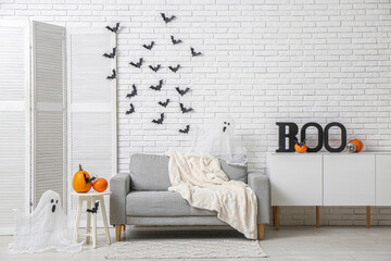 Interior of living room decorated for Halloween with sofa and paper bats