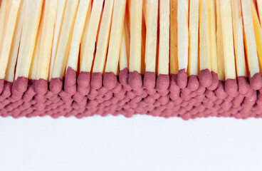 A close-up of many stacked matchsticks
