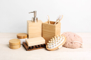 Fototapeta na wymiar Set of cosmetic products and bath supplies on light wooden table