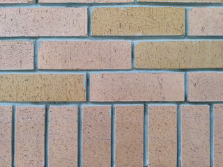 wall surface with rectangular bricks arranged vertically and horizontally, background
