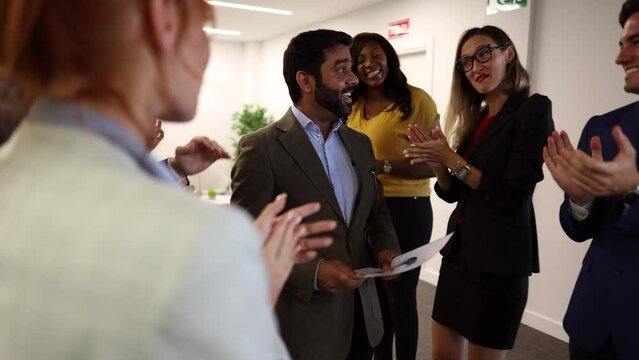 multiracial coworkers applaud for promotion, happy diverse employees applaud greeting indian coworker