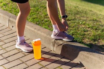 Running shoes - closeup of woman tying shoe laces.