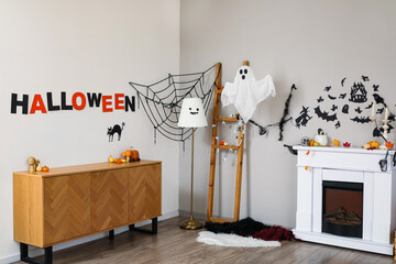 Interior of living room decorated for Halloween with fireplace and ladder