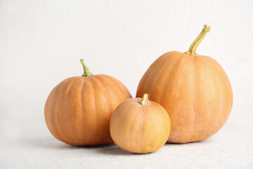 Raw pumpkins for Halloween celebration on white background