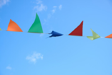Multicolored flags on a blue sky background