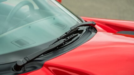 Windshield wipers on a red car - obrazy, fototapety, plakaty