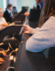 Process of checking in on a conference congress forum event, registration desk table, visitors and attendees receiving a name badge and entrance wristband bracelet and register electronic ticket