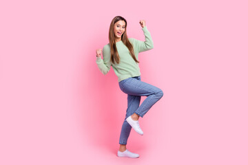 Full size body length photo of awesome young woman fists up celebrating weekend sushi discount delivery isolated on pink color background