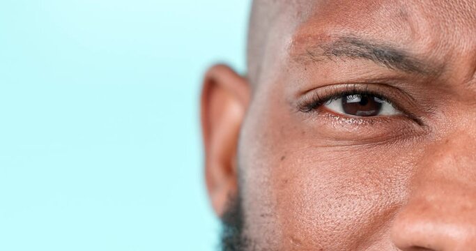 Confused, face and a black man on a studio background for doubt, question or thinking. Zoom, idea and closeup portrait of an African person with a frustrated expression and mockup space of an eye