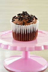 Mini chocolate cupcake on pedestal