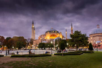 Fototapeta na wymiar Dramatic cloudy sky at twilight over Hagia Sophia mosque and Sultanahmet Square, Istanbul, Turkey