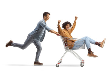 Caucasian man and african american man having fun and riding a shopping cart