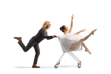Mature woman running and pushing a ballerina inside a shopping cart