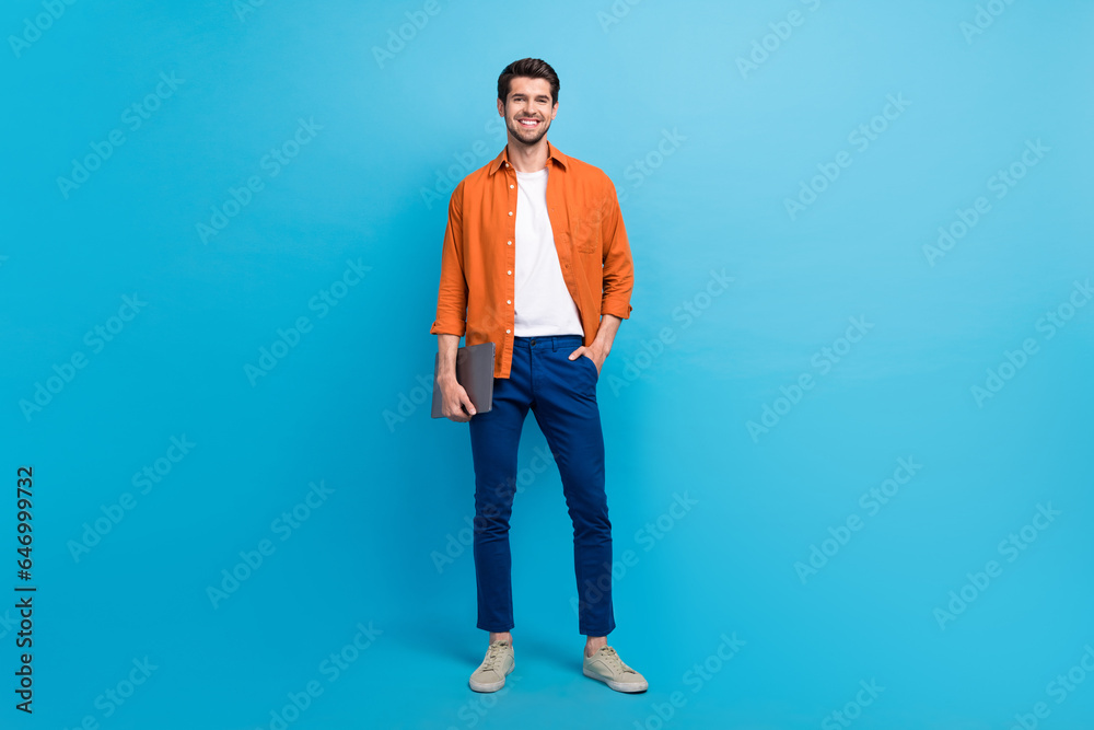 Poster full size photo of successful positive person put hand pocket hold netbook posing isolated on blue c