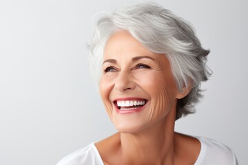 portrait of a beautiful smiling mature woman on a white background. perfect smile. copy space