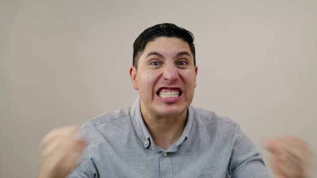 Irritated middle-aged Hispanic man shouting, cursing, waving his hands in anger. Hispanic man overwhelmed with negative emotions shouting at camera. High quality 4k footage