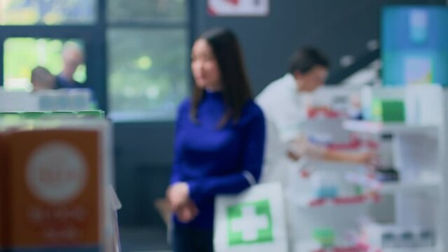 Portrait of happy client in drugstore looking at high SPF sunscreen products. Customer browsing through medical products in well supplied pharmacy shop, searching for prescribed pharmaceutical drug