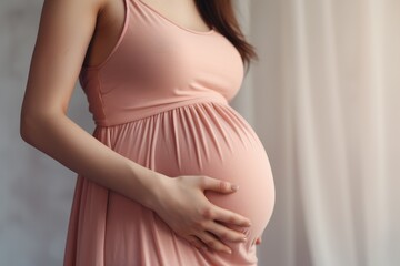Image of pregnant woman touching her belly with hands - obrazy, fototapety, plakaty