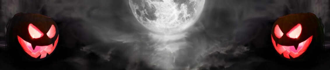 Two halloween pumpkins illuminated from the inside with dark background and full moon