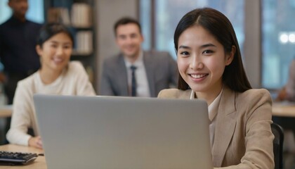 Radiant smiling Asian office girl immersed in work on her laptop computer against an office background