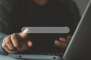 Searching Browsing Internet Data Information with blank search bar,  Browsing Internet data. Businessman's finger pointing at search icon, using a laptop computer for search engine optimization.