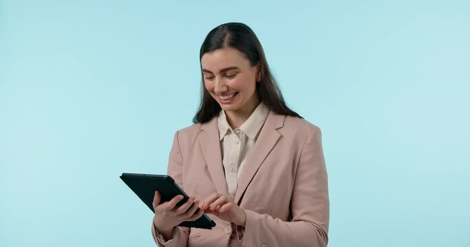 Business, tablet and woman typing for research or email on internet in studio on blue background with smile. Communication, digital tech and person on web for online marketing and feedback review