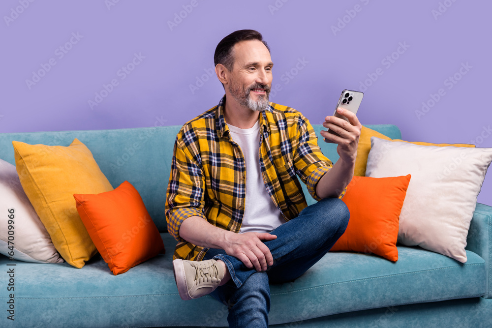 Poster Photo of successful bearded man influencer sit office comfy divan read sms order delivery service isolated on purple color background