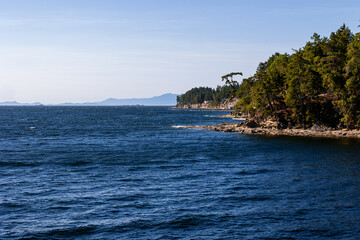 Fototapeta na wymiar Shoreline of Gabriola Island looking to the Malaspina Galleries and Vancouver Island and the Coast Mountains of British Columbia, Canada