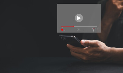 Watch captivating videos on a smartphone screen as a man taps to start live streaming. Immerse yourself in the digital world of technology, social media, and entertainment from the comfort of home.