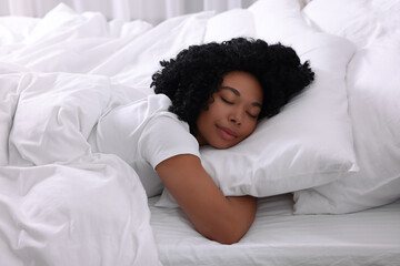 Beautiful young woman sleeping in soft bed