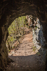 Trail with a tunnel in Jizera river valley near Semily, part of Riegrova stezka path, Czechia