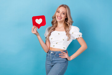 Photo of nice girl young age wear crop top blouse holding paper red heart symbol subscribe blogger heart isolated on blue color background