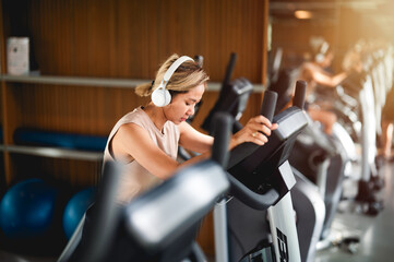 Sporty woman exercising on multistation at gym