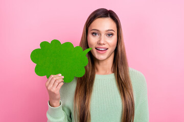 Photo of funny nice young woman hold green paper speech chatterbox announce her beauty store opening isolated on pink color background