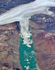 Aerial of Greenland glacier melting and breaking up into a fjord