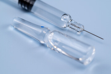 Ampoules filled with medicine and syringes