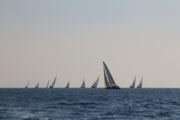 Sailing ship yachts with white sails in race the regatta in the open sea