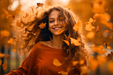 Fototapeta premium A beautiful girl throwing leaves in the forest, as the autumn season is approaching