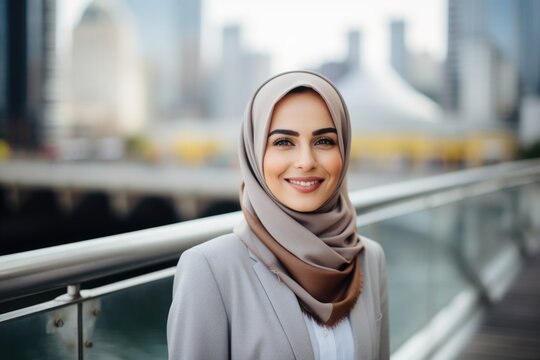 Smiling portrait of an arabic businesswoman wearing a hijab working in a startup company in a modern business office