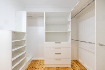 Walk in wardrobe new modern white walk in stylish pantry shelving and cabinetry - obrazy, fototapety, plakaty